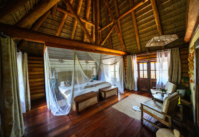 Kyaninga Lodge handcrafted log cottage Lake Kyaninga Rwenzori views Uganda