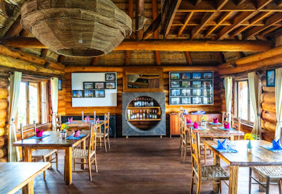 Kyaninga Lodge indoor dining room Elgon Olive Mvule furniture Kibale Uganda