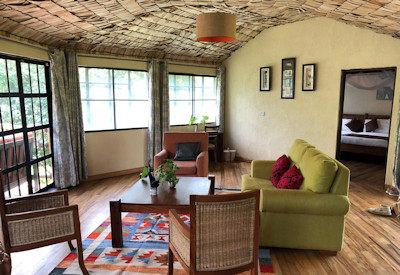 Mahogany Springs Lodge indoor lounge fireplace refurbished living room Uganda