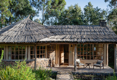 Mount Gahinga Lodge thatched banda private veranda Virunga volcano views Uganda
