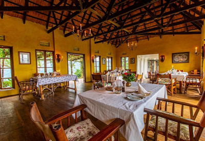 Ndali Lodge thatched dining room communal table fresh local cuisine Kibale Uganda