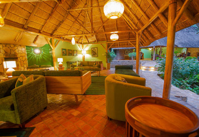 Primate Lodge Kibale lounge armchairs small library Kibale National Park Uganda