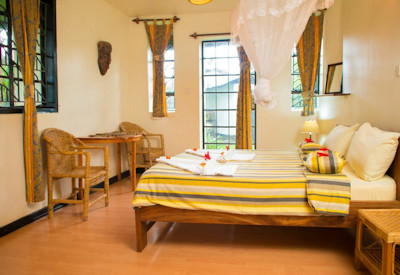 Travellers Rest Hotel spacious room Congo art colonial charm Mgahinga Uganda