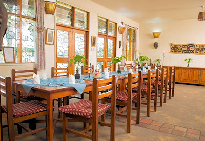 Travellers Rest Hotel dining Congolese art four-course set menu Mgahinga Uganda