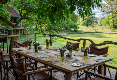 Shady open air seating area perfect for birding and tracking wildlife at Bilimungwe Bushcamp