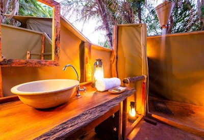 Busanga Plains Camp en-suite open-air bucket shower flush toilet Busanga Plains Zambia