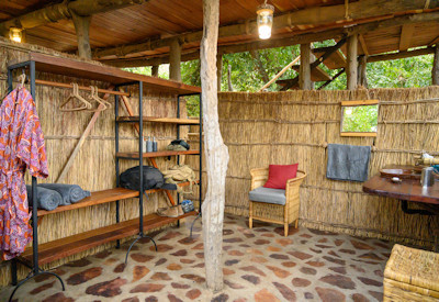 Rustic downstairs en-suite bathroom facilities inside an eco-friendly treehouse chalet at Chikoko Tree Trails Camp