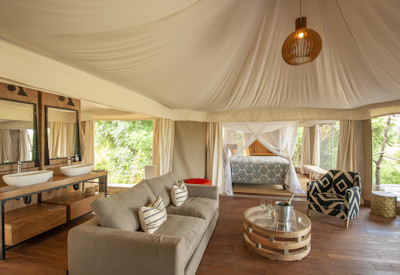Spacious luxury canvas safari suite featuring an elevated private viewing deck at Chikunto Safari Lodge