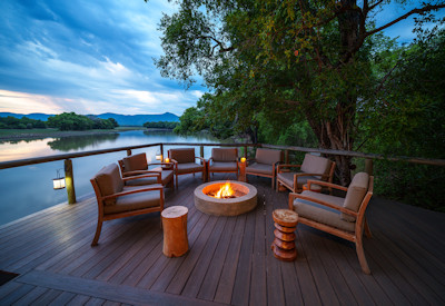 Spectacular sunset views over the oxbow lagoon and sweeping floodplains from the decks of Chindeni Bushcamp