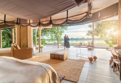 Spacious and modern luxury villa interior featuring a cooled sleeping area and panoramic river views at Chinzombo Safari Camp