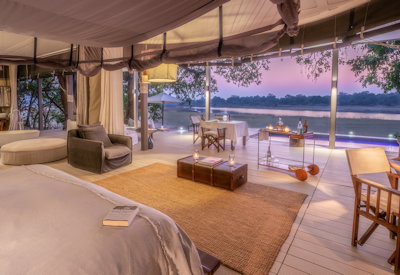 Elegant en-suite bathroom featuring a luxurious deep soaking tub and premium modern amenities at Chinzombo Safari Camp
