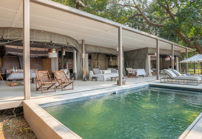 Open-plan main lounge and dining area blending contemporary architectural design with authentic bush elegance at Chinzombo Safari Camp