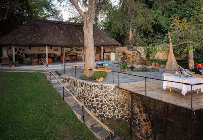 Chundukwa River Lodge swimming pool shaded gardens Zambezi River Livingstone Zambia