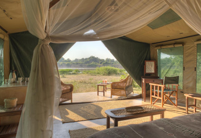 Comfortable safari tent blending into the bush at Flatdogs Camp, South Luangwa National Park, Zambia