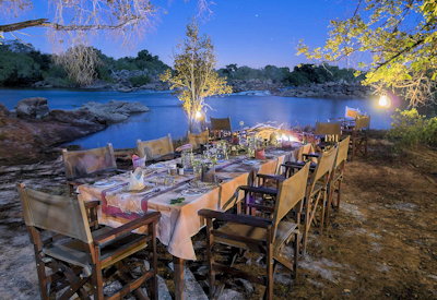 Kaingu Lodge outdoor dining granite boulders Kafue River Kafue National Park Zambia