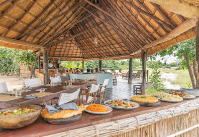 Elevated main lounge and dining deck providing a comfortable shaded retreat with sweeping river views at Kakuli Bush Camp