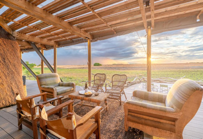 King Lewanika Lodge serene lounge bar live waterhole views Liuwa Plain National Park Zambia