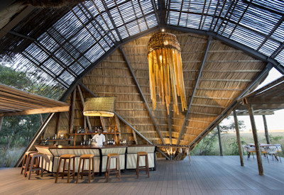 King Lewanika Lodge thatched central area wooden deck firepit Liuwa Plain views Zambia