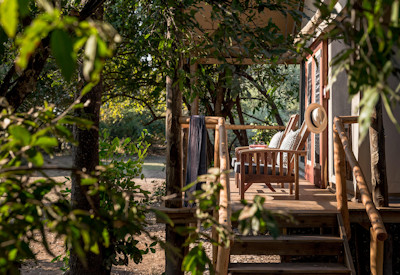Kulandila Camp central main lodge lounge area with comfortable seating and rustic thatch architecture