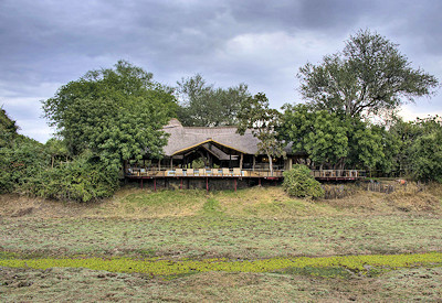 Sweeping views of the vibrant floodplains and wandering wildlife from the elevated private decks at Lion Camp
