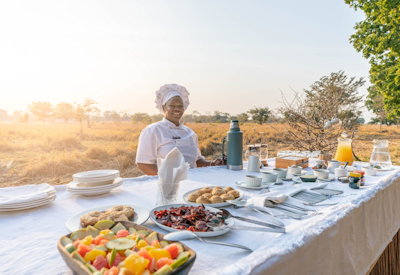 Freshly prepared safari meals cooked over an open fire and served al fresco at Luwi Bush Camp