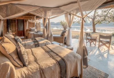 Inviting riverside plunge pool offering a refreshing escape with views of wildlife at Mchenja Camp