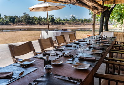 Open-air thatched main lounge and dining area providing a relaxed and comfortable bush setting at Mchenja Camp