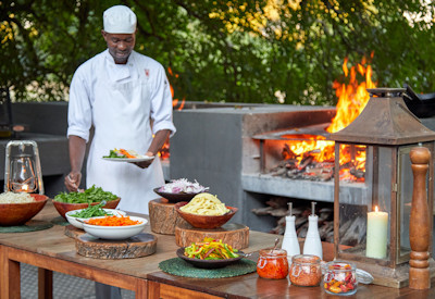 Delicious gourmet buffet dining served on the wide open air wooden viewing decks at Mfuwe Lodge