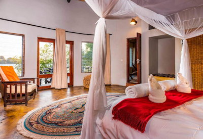 Mukambi Safari Lodge large en-suite bedroom thatched chalet Kafue River Zambia