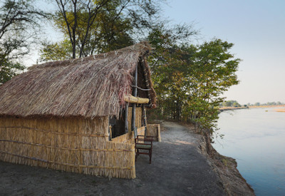 Charming open-air en-suite bathroom featuring a flushing toilet and bucket shower under the stars at Mwaleshi Camp