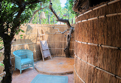 Mwamba Bush Camp outdoor bathroom bucket shower hot water skylight stars Zambia