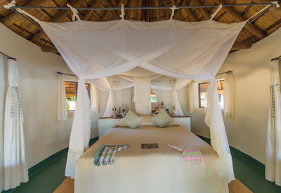Nsefu Camp large bedroom raised bed moonlight Luangwa River views Zambia