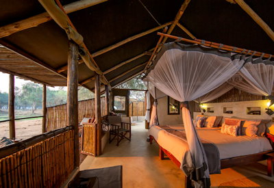 Old Mondoro thatched bedroom Egyptian cotton shaded timber sun deck day bed Zambia