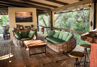 Modern A-frame canvas safari tent with an elevated private wooden deck at Shawa Luangwa Camp
