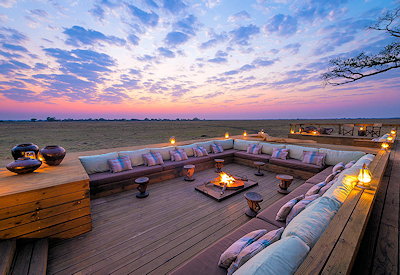 Shumba Camp contemporary deck firepit sundowner cocktails Busanga Plains Kafue Zambia