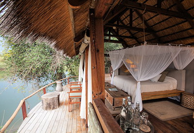 Sindabezi Island Camp open-fronted thatched chalet Zambezi floodplain views Zambia