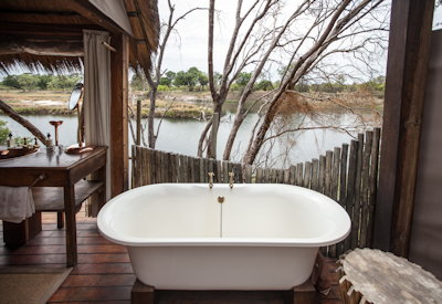 Sindabezi Island Camp freestanding bathtub outdoor shower honeymoon chalet Zambia