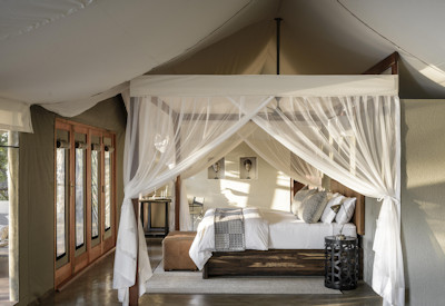 Sungani Lodge spacious luxury suite interior featuring polished concrete floors and panoramic wilderness views
