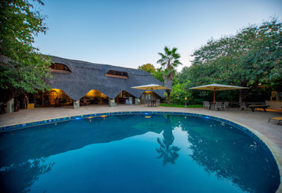 Bayete Guest Lodge teardrop swimming pool lush tropical garden Victoria Falls Zimbabwe