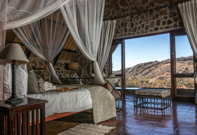 Big Cave Camp spacious bedroom rainfall shower en-suite Matobo Hills Zimbabwe