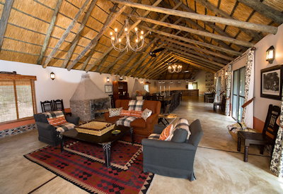 Camelthorn Lodge stone central area three fireplaces two lounges open bar Hwange Zimbabwe