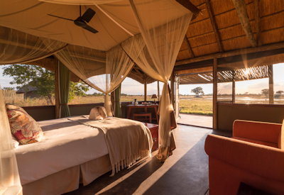 Camp Hwange thatched safari chalet private verandah waterhole views Hwange Zimbabwe