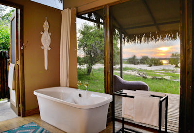 Chundu Island Lodge en-suite freestanding bath outdoor shower Zambezi River Zimbabwe