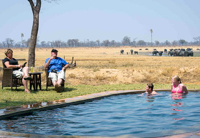Davisons Camp swimming pool next to waterhole Hwange National Park Zimbabwe