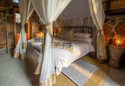 Bumbusi Wilderness Camp fireside chairs mature trees boma area Hwange Zimbabwe