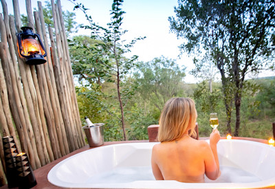 Masuwe Lodge en-suite bathroom outdoor bathtub incredible bushland views Zimbabwe