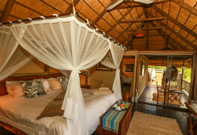 Nehimba Lodge large thatched safari chalet teak deck waterhole views Hwange Zimbabwe