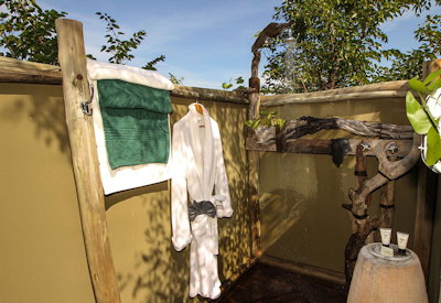 Nehimba Lodge outdoor shower suite teak deck waterhole views Hwange Zimbabwe