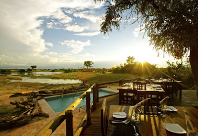Nehimba Lodge wooden viewing deck Hwange sunset dry season wildlife Zimbabwe