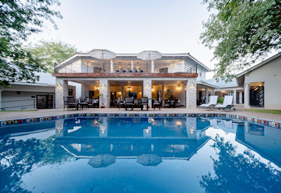 Nkosi Guest Lodge swimming pool lush gardens Victoria Falls Zimbabwe